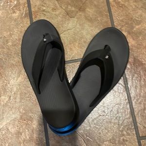 Black Nike flip flops. Never worn outside. Like new.